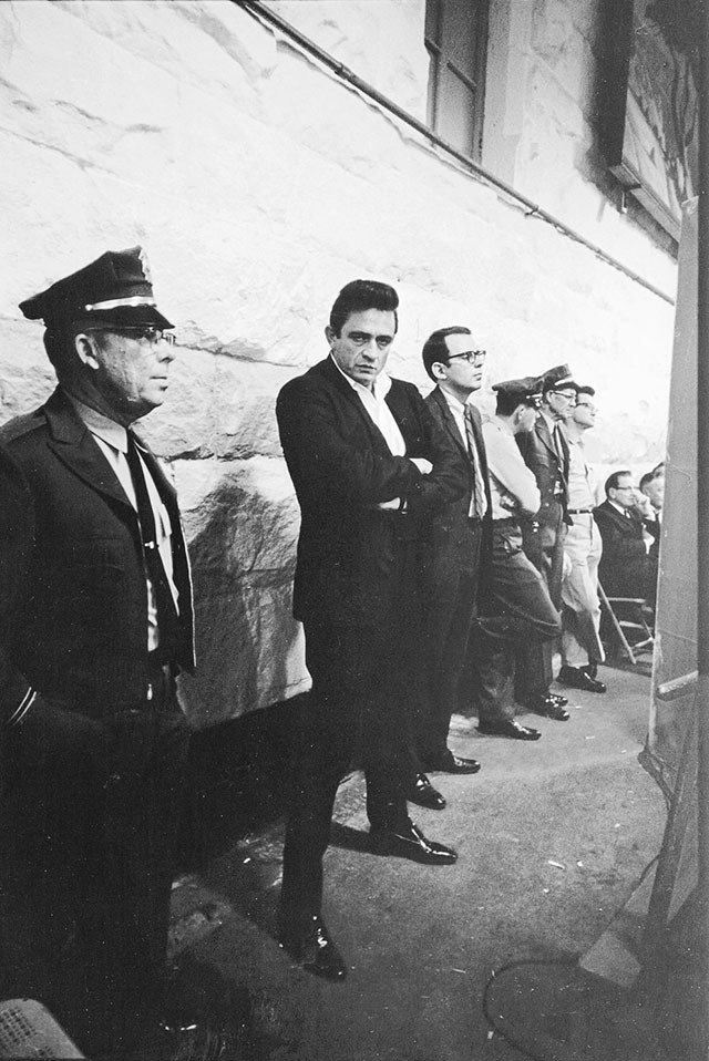 Cash at 1968’s historic Folsom Prison concert; to his left, Hilburn, the only music journalist present - JIM MARSHALL