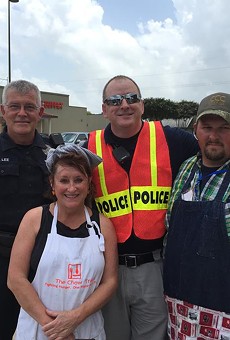 Cheever with volunteer helpers on Tuesday, May 26. The truck was parked next to a heavily hit strip center and neighborhood in San Marcos.