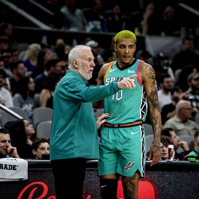 Spurs foward Jeremy Sochan talks to Hall of Fame coach Gregg Popovich before going into a game.