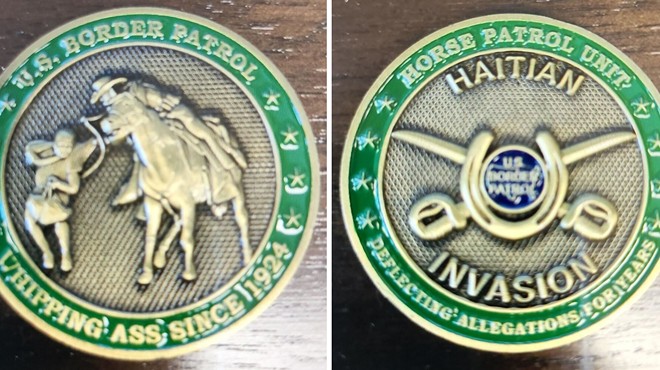 One side of the coin depicts a mounted U.S border patrol agent wrangling a Haitian migrant.