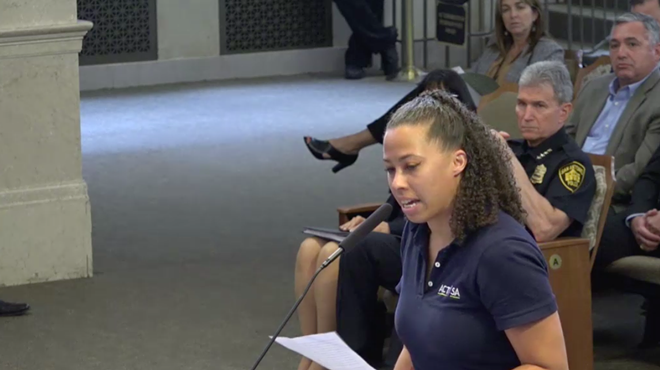 Police accountability activist Ananda Tomas speaks during Thursday's council meeting.