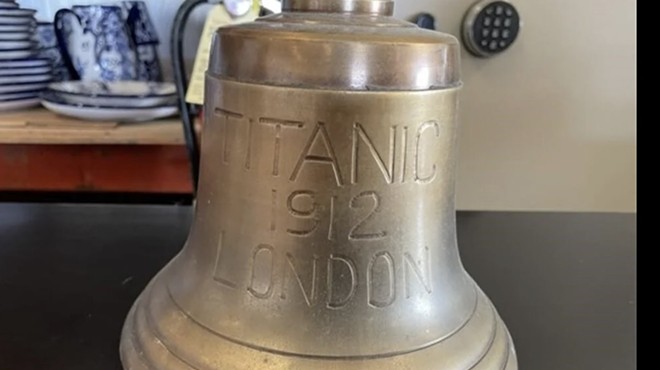 This replica brass bell is among the items included in the auction.