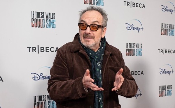 Elvis Costello talks with hands at an appearance to promote the 2022 music documentary If These Walls Could Sing.