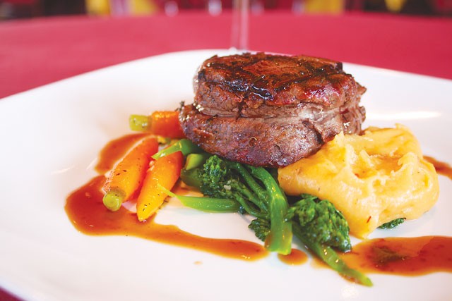 Filet mignon on a bed of vegetables from McCullough Avenue Grill. - Veronica Luna