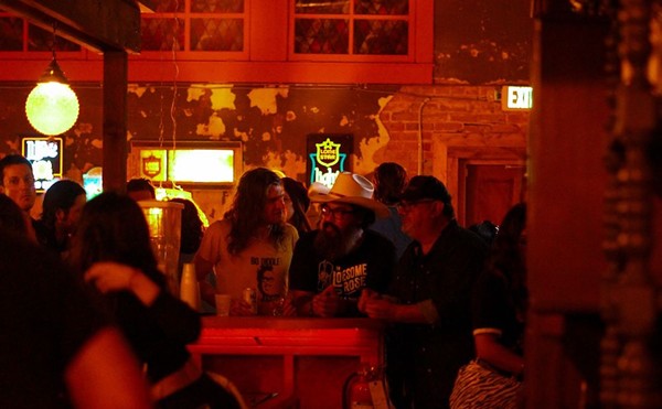Patrons enjoy adult beverages surrounded by' 70s decor during the opening night of Slow Ride.
