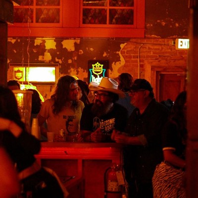 Patrons enjoy adult beverages surrounded by' 70s decor during the opening night of Slow Ride.