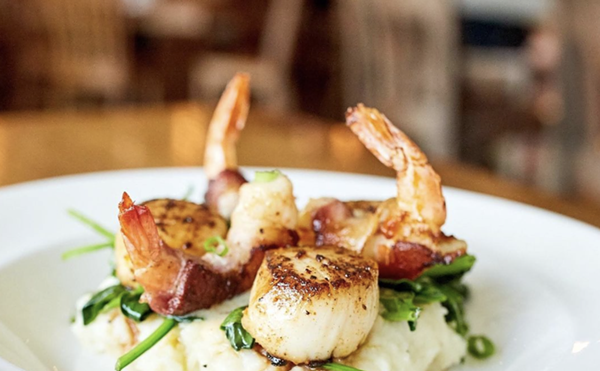 Seared Georges Bank scallops with applewood bacon-wrapped shrimp is one of the entrees served at Fish City Grill locations.