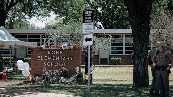Law enforcement personnel stand guard outside Robb Elementary following the May 2022 shooting.