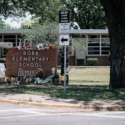 Law enforcement personnel stand guard outside Robb Elementary following the May 2022 shooting.