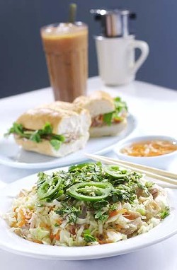 (From front) Vietnamese chicken salad - shredded chicken tossed with light seasoned vegetables and marinated shredded cabbage; banh mi thit (French sandwich) - three kinds of Vietnamese ham, sauce, and vegetables on French bread; Vietnamese iced coffee.