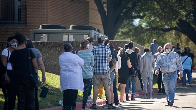 People wait in line to vote at Audelia Road Branch Library on the first day of early voting in Dallas on Oct. 13, 2020.