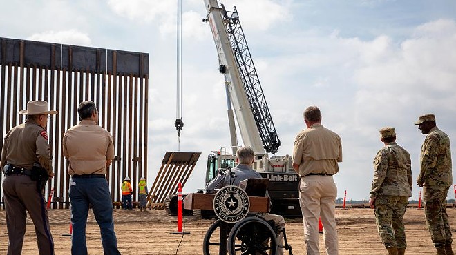 Gov. Greg Abbott watched a crane lifting a section of the border wall in place near the Rio Grande after he unveiled the new wall during a press conference last week.