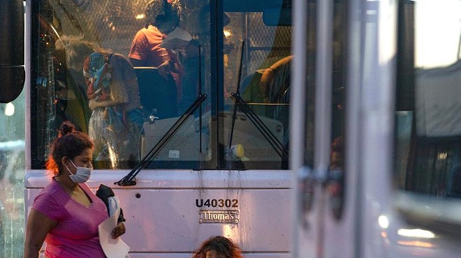 Asylum seekers disembark a bus in front of the Catholic Charities Humanitarian Respite Center in McAllen on Aug. 1, 2021.