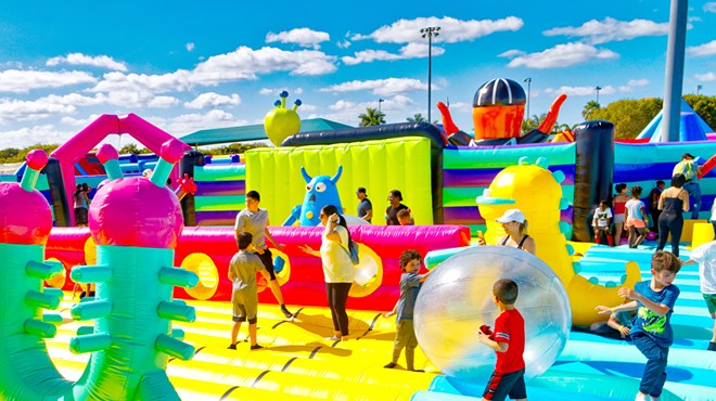 Children play inside the Sports Slam inflatable attraction.