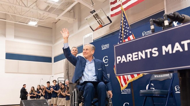 Gov. Greg Abbott waves to the crowd during a Houston stop on his tour to drum up support for school vouchers.