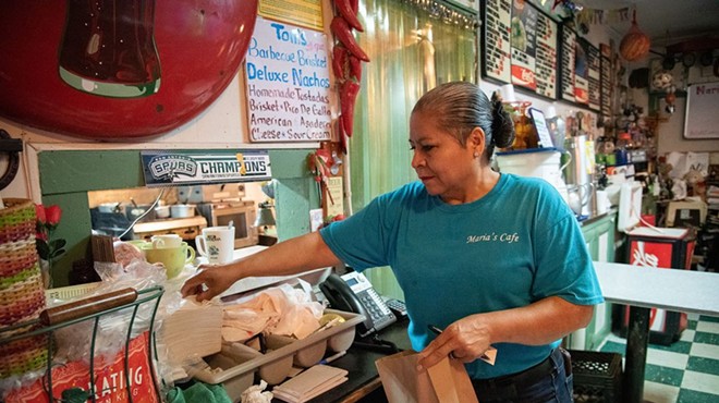 Maria Beza, owner of Maria’s Cafe on Nogalitos Street, completes an order on Thursday.