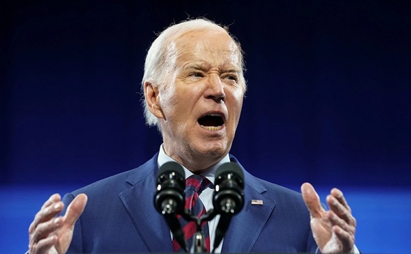 Joe Biden speaks from a podium in June of this year.