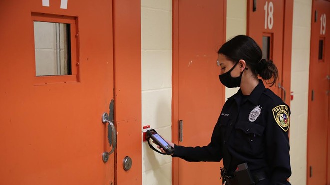 A deputy at the Bexar County Jail checks in on inmates using the facility's digital system.