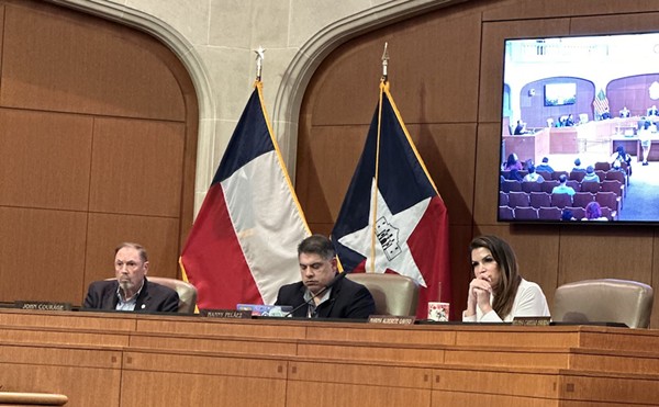 District 8 City Councilman Manny Pelaez clacks away on his laptop while San Antonio residents express their concerns about the bloodshed in Gaza.