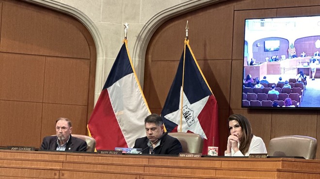 District 8 City Councilman Manny Pelaez clacks away on his laptop while San Antonio residents express their concerns about the bloodshed in Gaza.