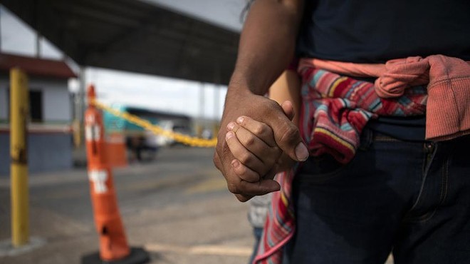 A Honduran asylum seeker holds his daughters’ hand at an immigration checkpoint in Nuevo Laredo. The pair were promptly returned to Mexico to await a court hearing under the Migrant Protection Protocols.