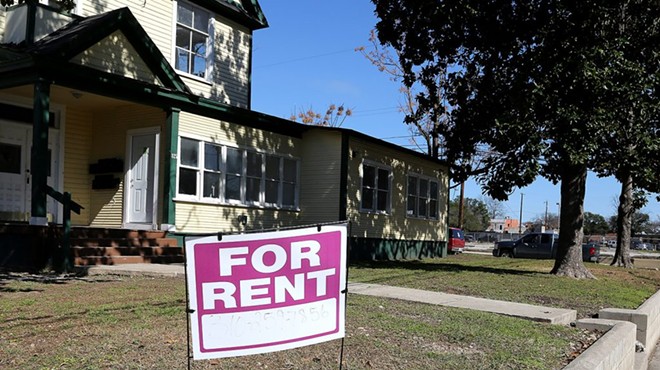 A "For Rent" signs stands in the yard of a home in San Antonio, where the median monthly rent is $1,270.
