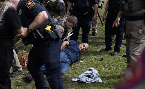 Carlos, a FOX 7 photojournalist, lays on the ground as he is arrested while covering a pro-Palestinian demonstration at the University of Texas at Austin on April 24, 2024.
