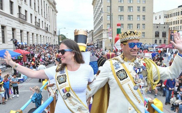 Kenneth "Ken" Flores (right) waves to the crowd during his time as Rey Feo LXX.