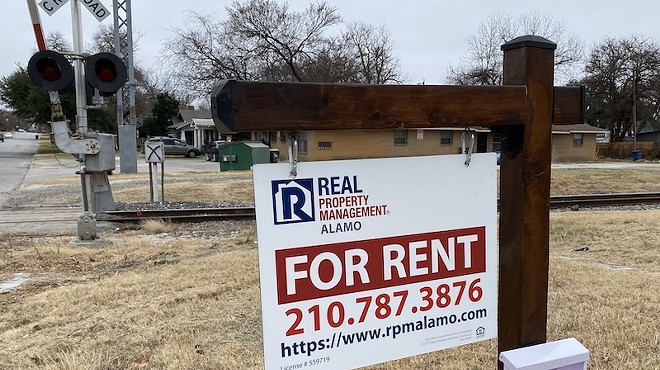 A sign stands in front of a rental property in a San Antonio neighborhood.