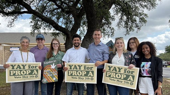 Prop A supporters including Democratic U.S. House candidate Greg Casar (fourth from left) pose with signs.