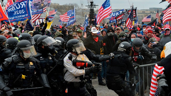 Police battle with supporters of Donald Trump as they breach barriers around the U.S. Capitol on January 6.