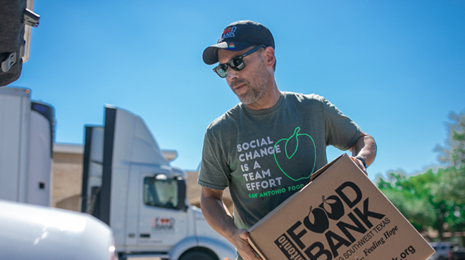 Food Bank CEO Eric Cooper loads a food box into a vehicle in Uvalde, Texas.