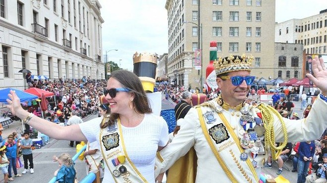 Kenneth "Ken" Flores (right) waves to the crowd during his time as Rey Feo LXX.