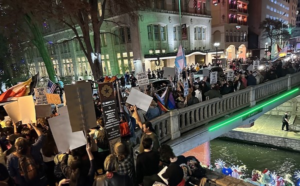 Pro-LGBTQ+ demonstrators assemble outside San Antonio's Aztec Theatre last December to counter a protest by an armed militia group.