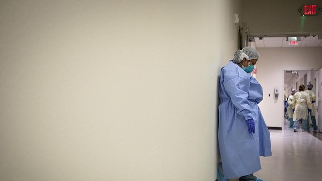 A nurse briefly rests against a wall in the COVID-19 unit at Doctors Hospital at Renaissance Health System in Edinburg.