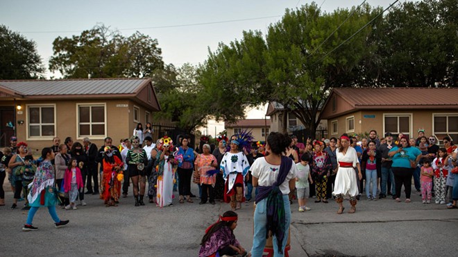 Attendees watch as a Día de los Muertos procession continues through the Alazán-Apache Courts in San Antonio on Nov. 1, 2022.