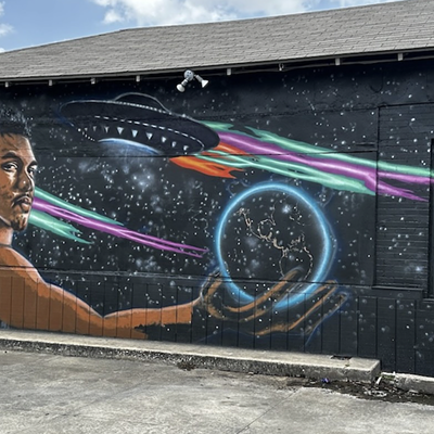 The new extraterrestrial-themed Wemby mural shows the French phenom holding the planet Earth.