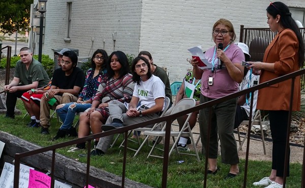 Soap Factory tenant Carmen Cruz tells her story during Monday's rally.