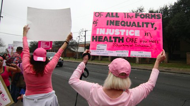 Protesters hold up signs at a pro-Planned Parenthood rally in San Antonio.