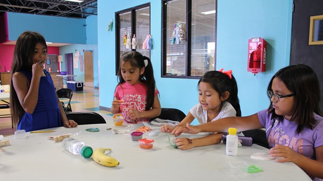 Schoolchildren engage in a San Antonio Food Bank educational program. A new report urges policymakers to make sure kids' basic needs, including nutrition and stable housing, are being met.