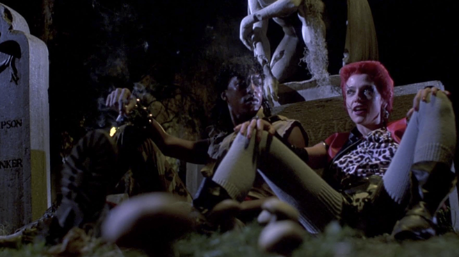 Miguel Nunez and Linnea Quigley share a scene in the graveyard in 1985's Return of the Living Dead.