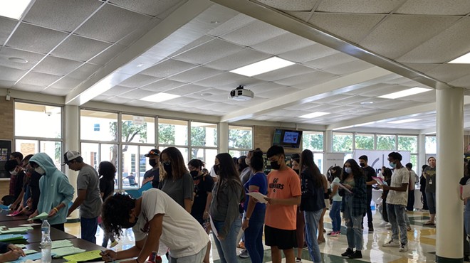 Students line up to register this week at NISD's Holmes High School last year.