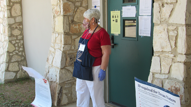 A poll worker stands outside the voting site at San Antonio's Lion's Field.