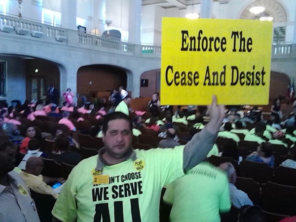 A Yellow Cab driver protests ride-share companies Uber and Lyft during a 2014 summer committee meeting. - MARK REAGAN