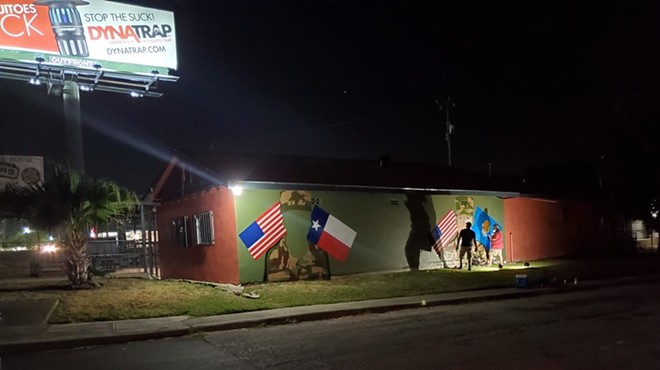 Local artist Ghost works through the night to complete a tribute mural in honor of deceased US Army soldiers Guillen and  Morales.