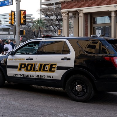 A San Antonio Police Department vehicle parks on a downtown street.