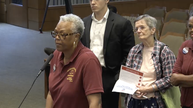 Community members take turns at the mic during Thursday's City Council meeting.