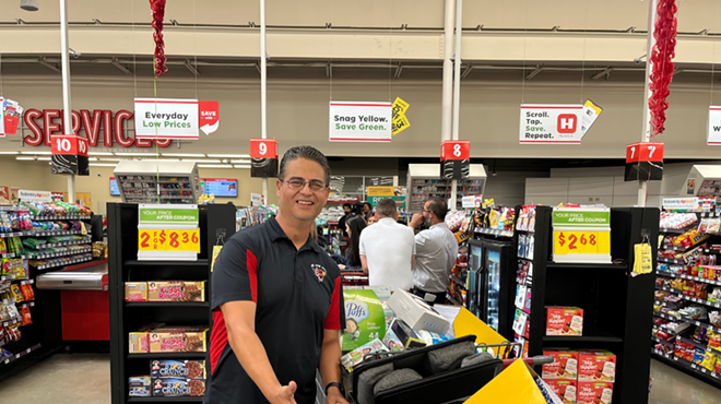 Southside ISD teacher Jason Garcia stands in line with his pickings from a shopping spree at a local H-E-B store.