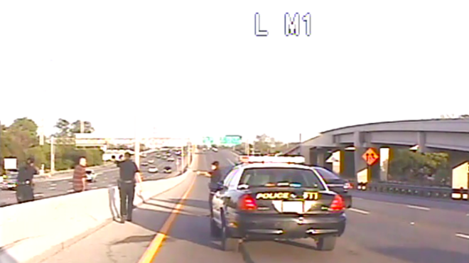 A screen grab from dash-cam footage provided to the San Antonio Current shows Jesse Aguirre moments before being pinned down along the highway in 2013.