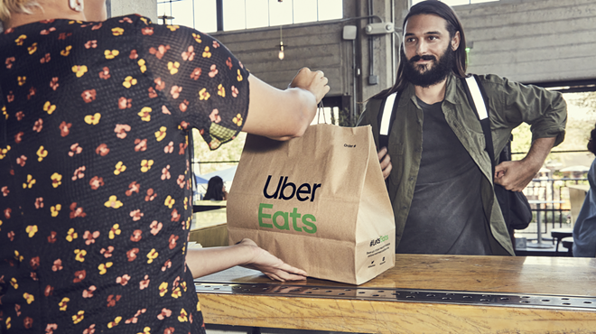 An Uber Eats courier picks up an order.